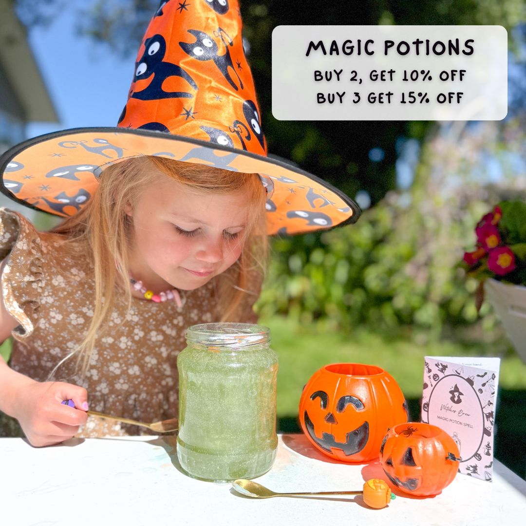 A little girtl in a orange witches hat, brews a magical green magic potion